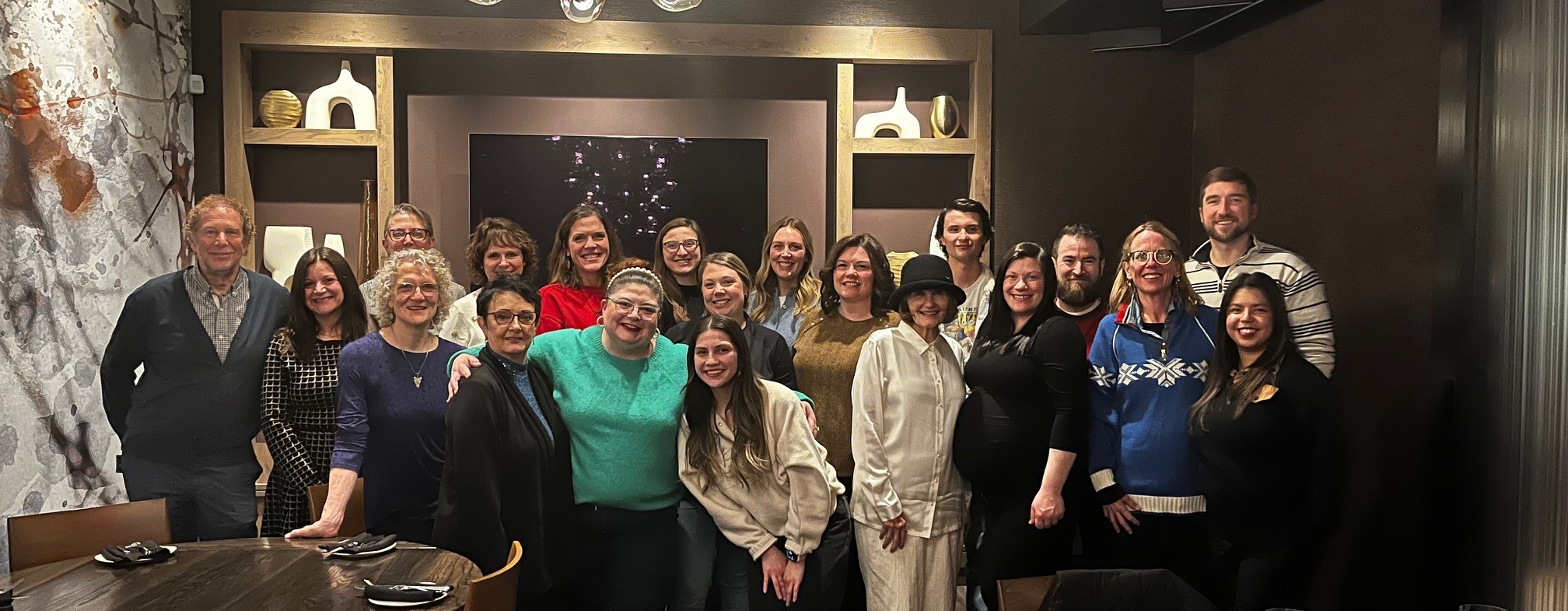 A group of employees in holiday outfits at a restaurant