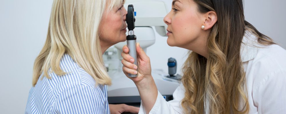 Dr. Cordoba examining a patient's eye with a medical tool