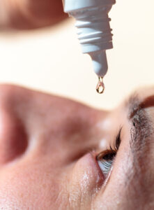 Male using eye drops